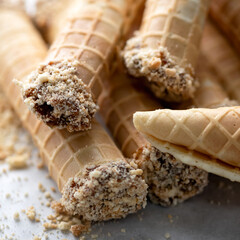 Wafer rolls with condensed milk. Close-up shot. Soft focus.