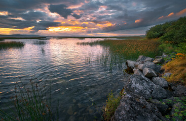 Beautiful sunset landscape scenery with dramatic cloudy skies over Corrib lake in Galway, Ireland 