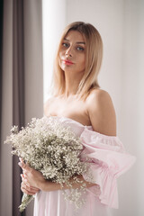 beautiful young girl in white dress holding a boquet of white flowers