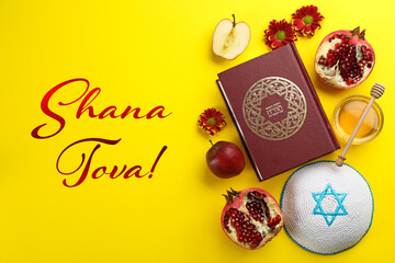 Flat lay composition with Rosh Hashanah holiday attributes on yellow background. Torah book with...