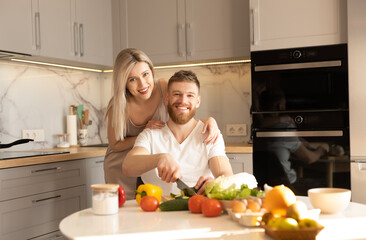 Smiling european couple on kitchen at home