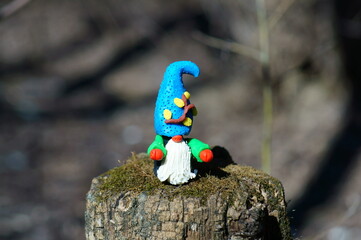 Figure of a dwarf in the forest. A fairy-tale character.