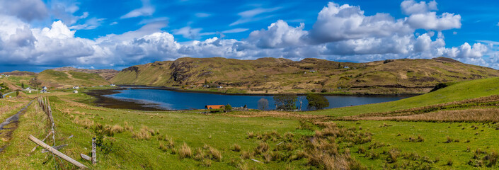 Fototapeta na wymiar A panorama view across Loch Mor on the island of Skye, Scotland on a summers day