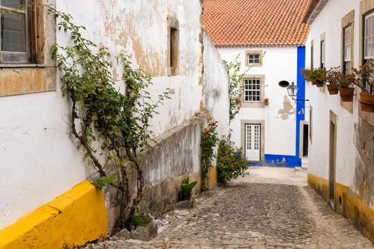 Obidos, Portugal - June 30, 2021: Picturesque street in the midieval town of Obidos