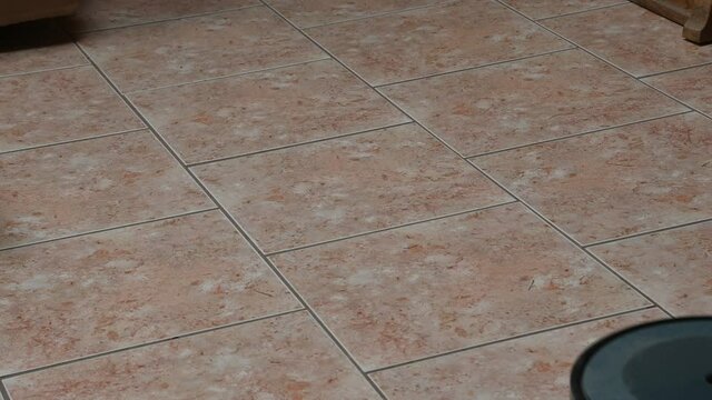 EL PASO, UNITED STATES - Jul 02, 2021: The robot Roomba cleaning and vacuuming a tile floor