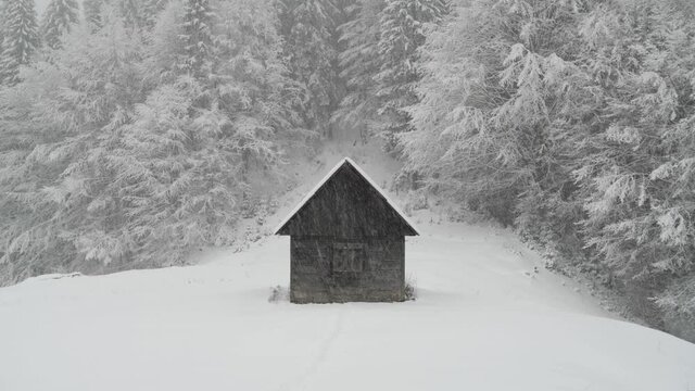 Fantastic winter footage with wooden cabin in snowy mountains