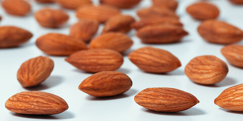 Background of almonds. Fried almonds. Scattered almond grains. Background for advertising