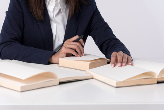At library,woman work with laptop and serch information, hand open book,stack of books at side. Education background.