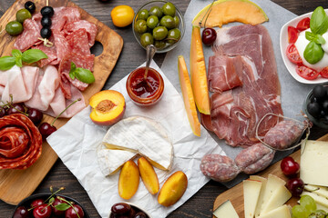 Salami,  prosciutto ham, olives, cherry, grape. food snacks for an aperitif, a picnic, for a festive dinner or a party. 