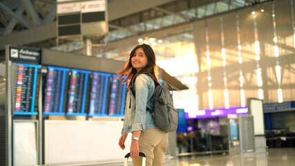 Asian traveler woman walking in airport terminal - obrazy, fototapety, plakaty