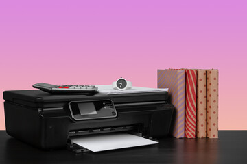 Compact home laser printer against pink background