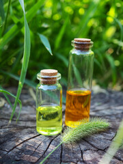 Several glass bottles with oil and essence on a natural background, a banner for alternative medicine, a copy of the space of a medicine from nature