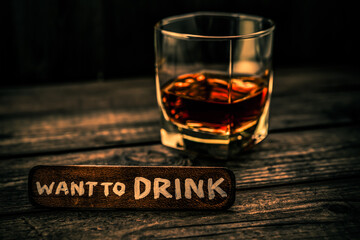 Glass of brandy with the wooden plank on it is an inscription 