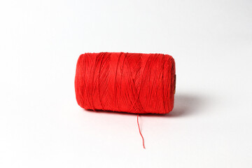 A spool of red thread. White background.