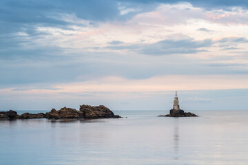 Fototapeta na wymiar Amazing sunset view with an old lighthouse at the Black Sea coast