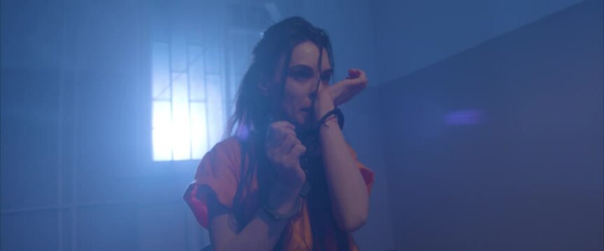 crazy girl  in the interrogation room in handcuffs