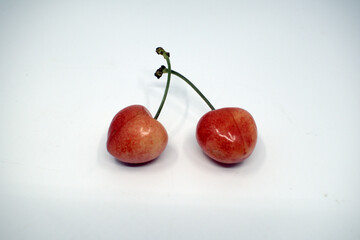 Yellow sweet cherry. Blue background.