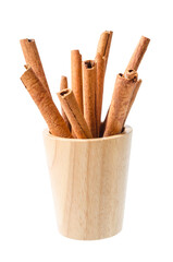 Cinnamon sticks in wooden bowl isolated on white background.