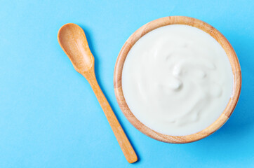 Greek yogurt in wooden bowl.