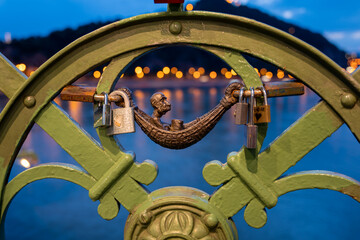 Close-up of a statue on the Liberty Bridge in Budapest, a man laying in a hammock