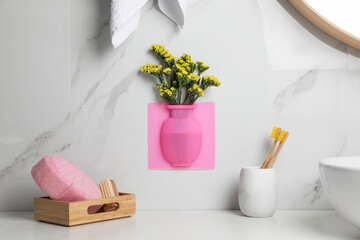 Obraz na płótnie Canvas Silicone vase with flowers on white marble wall over countertop in stylish bathroom