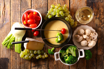 cheese fondue with vegetable and wine glass
