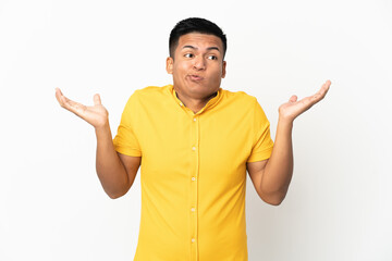 Young Ecuadorian man isolated on white background having doubts while raising hands