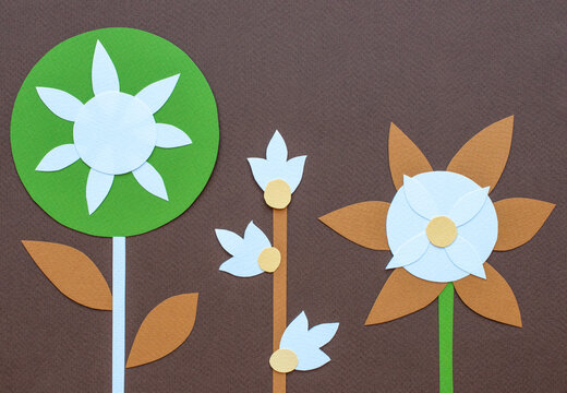 Brown Background With Paper Cut Flowers.