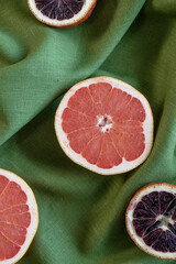 Pink grapefruit on fabric. Selective focus on home decor, natural eco-friendly linen in interior.