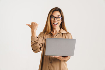 Naklejka premium Happy woman using laptop computer isolated on a white