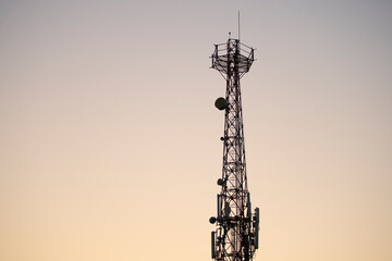 Communications tower with sunset sky background 