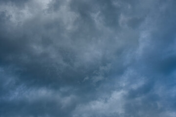 Gray and white rolling puffy clouds floating in the sky. Concept Storm Clouds Raining.