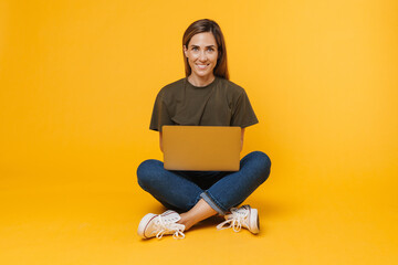 Fototapeta na wymiar Happy woman using laptop computer isolated on a white