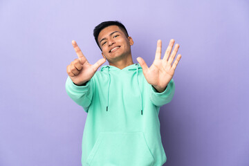 Young Ecuadorian man isolated on purple background counting seven with fingers