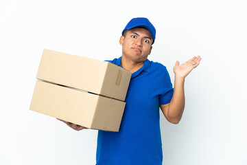 Delivery Ecuadorian man isolated on white background having doubts while raising hands