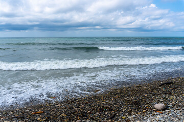 small storm on the sea, waves hitting the shore