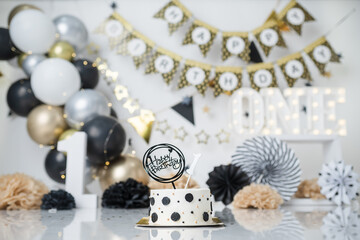 Celebrating 1 year old. Gold theme, black and white. with balloons and lights