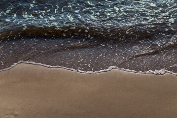 Soft wave of the sea on the sandy beach.Soft focus,blurred image.
