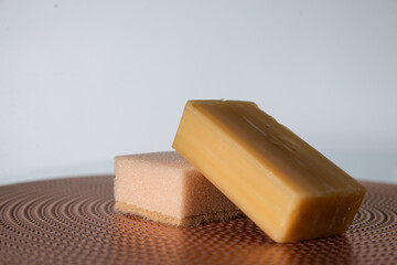 a bar of soap and a sponge for dishes