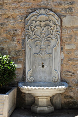 Drinking water tap, city water column and stone water bowl.