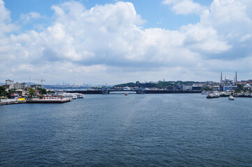 Fototapeta na wymiar Panorama of the Galata Bridge from the side of the Golden Horn Bay. Cloudy day in the city.