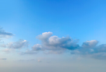 Looking up at the blue sky and white clouds background