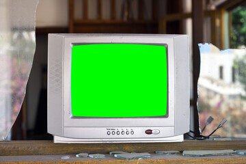 An old silvery green-screen TV for adding video sits in an abandoned hotel. Vintage TVs 1980s 1990s...