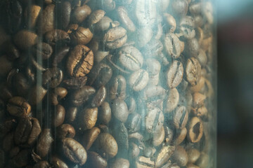 dark roasted coffee beans in a glass flask in the vintage cafe