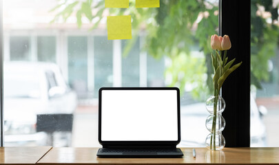Cropped shot of digital tablet with blank white screen, display for reading informations on mock-up tablet.