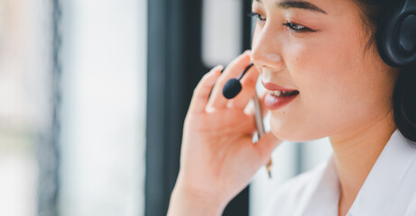 Portrait of happy smiling female customer support phone operator at workplace,call-center agent or customer service position talking on the phone.