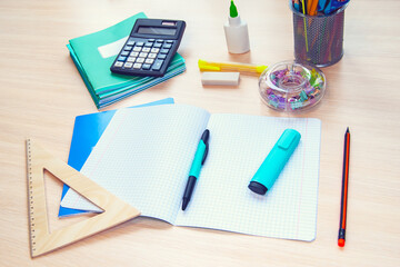 Various office supplies on a light wooden background, a table, with space for text. Back to school. The concept of education, upbringing and return to school.