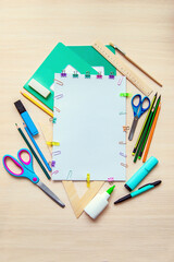 A frame of various stationery on light background, flat lay with space for text. Back to school