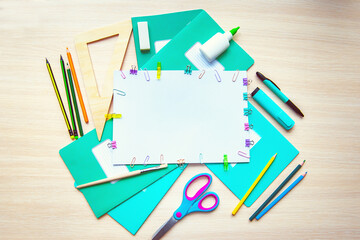 A frame of various stationery on light background, flat lay with space for text. Back to school