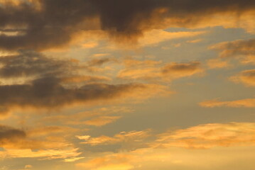 Naklejka na ściany i meble sky and golden clouds at sunset